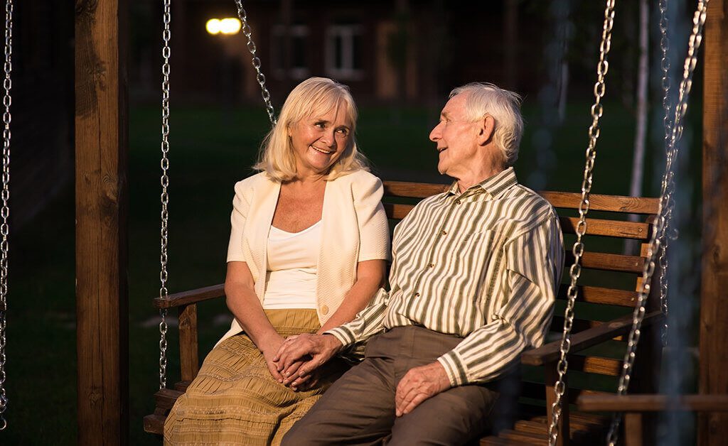 senior couple on swinging bench