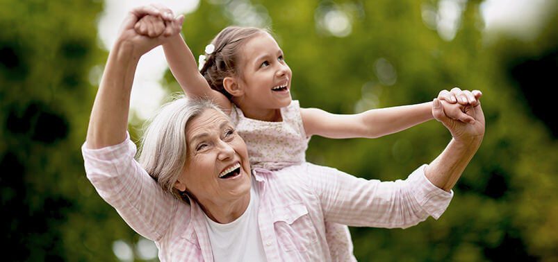 grandmother with granddaughter on her back