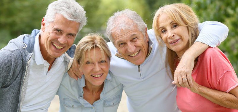 seniors friends with their arms around each other