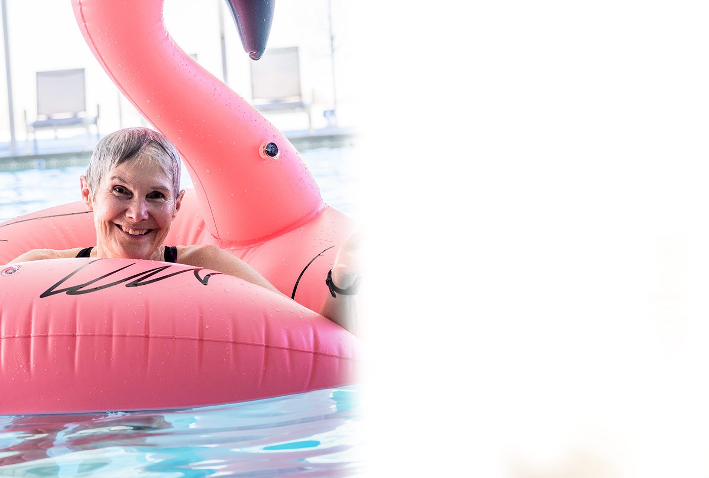 Senior woman in a flamingo pool float